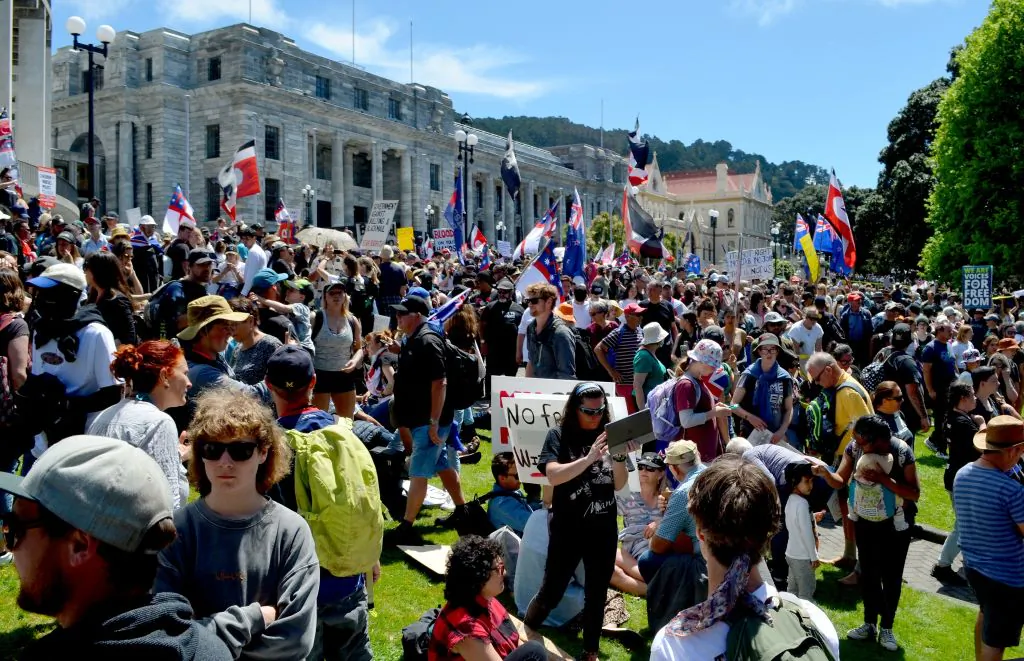 Protesters attend a Freedom and Rights Coalition demonstration to demand an end to COVID-19 restrictions and mandatory vaccination outside the Parliament House building on Nov. 9, 2021, in Wellington, New Zealand. (Neil Sands/AFP via Getty Images)