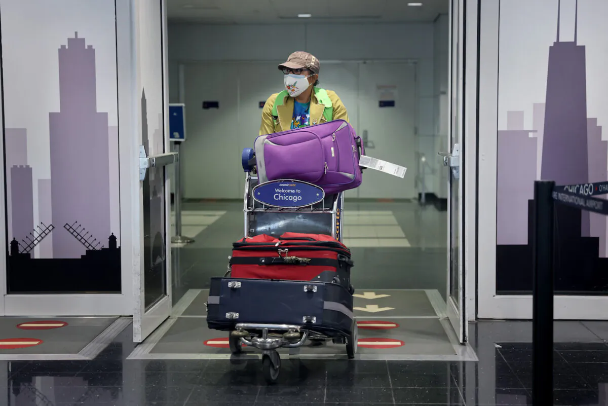 A traveler arrives at the international terminal of O'Hare International Airport in Chicago, Illinois on Nov. 08, 2021. (Scott Olson/Getty Images)