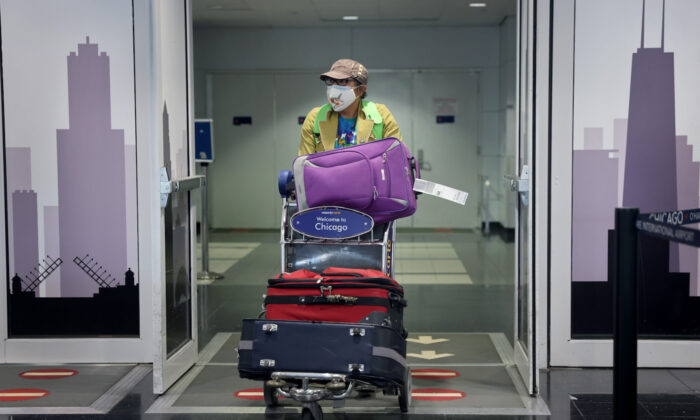 A traveler arrives at the international terminal of O'Hare International Airport in Chicago, Illinois on Nov. 08, 2021. (Scott Olson/Getty Images)