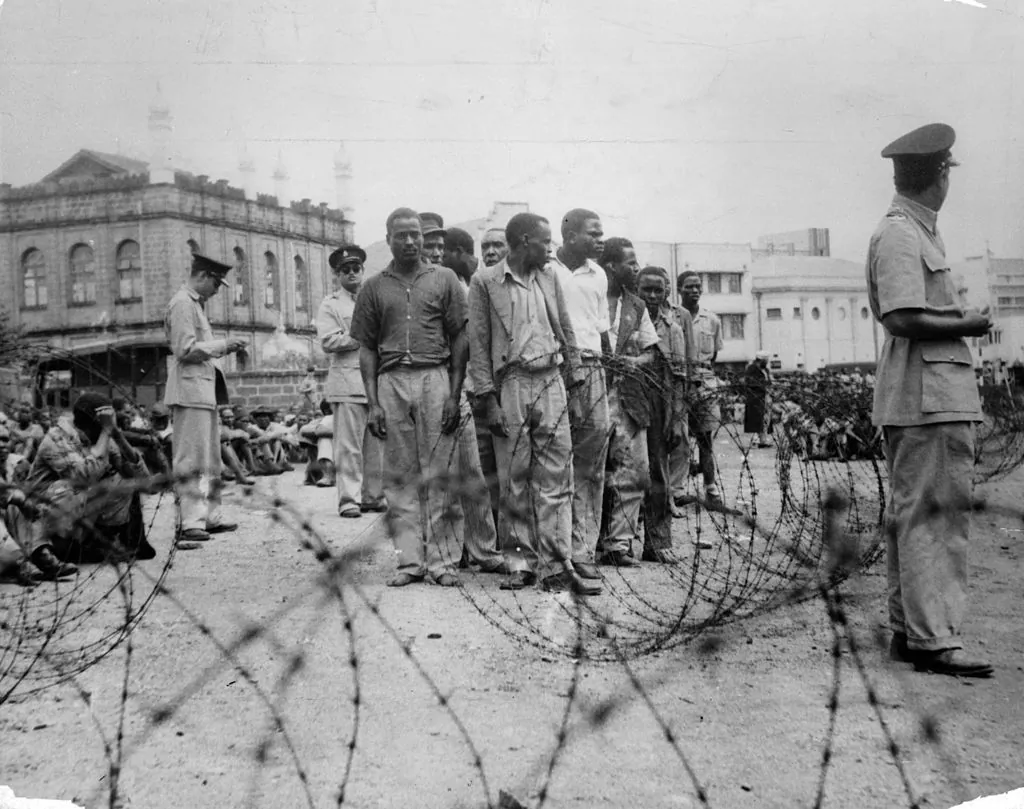 Mau Mau suspects rounded up by police outside a camp in Manyani, Kenya, 1955. (Authenticated News/Archive Photos/Getty Images)