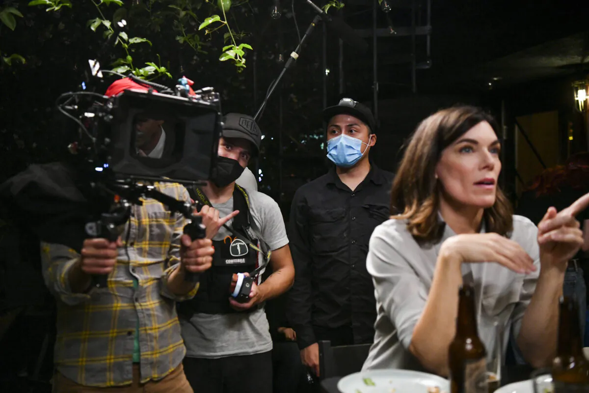Cameramen Aaron Wise (L) and Rigel “Che” Yaluk(2L) with film actor Amy Motta (R) during production of the indie feature film, “The Star City Murders” on July 1, 2021, in Los Angeles, Calif. (Rodin Eckenroth/Getty Images)