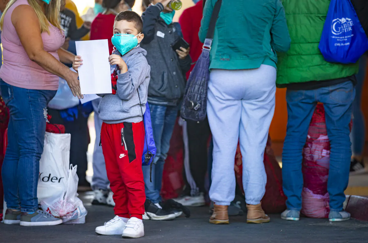 Immigrants captured by border patrol agents are transferred to a hotel in Indio, Calif., on Oct. 18, 2021. (John Fredricks/The Epoch Times)
