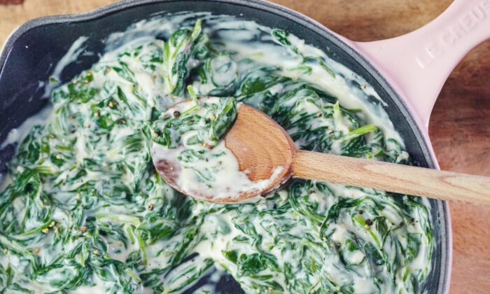 Good creamed spinach is swathed in a gentle sauce of aromatics and fresh spices, with just enough creamy half-and-half and grated Parmesan cheese to hold the leaves together. (Lauren Volo/TNS)