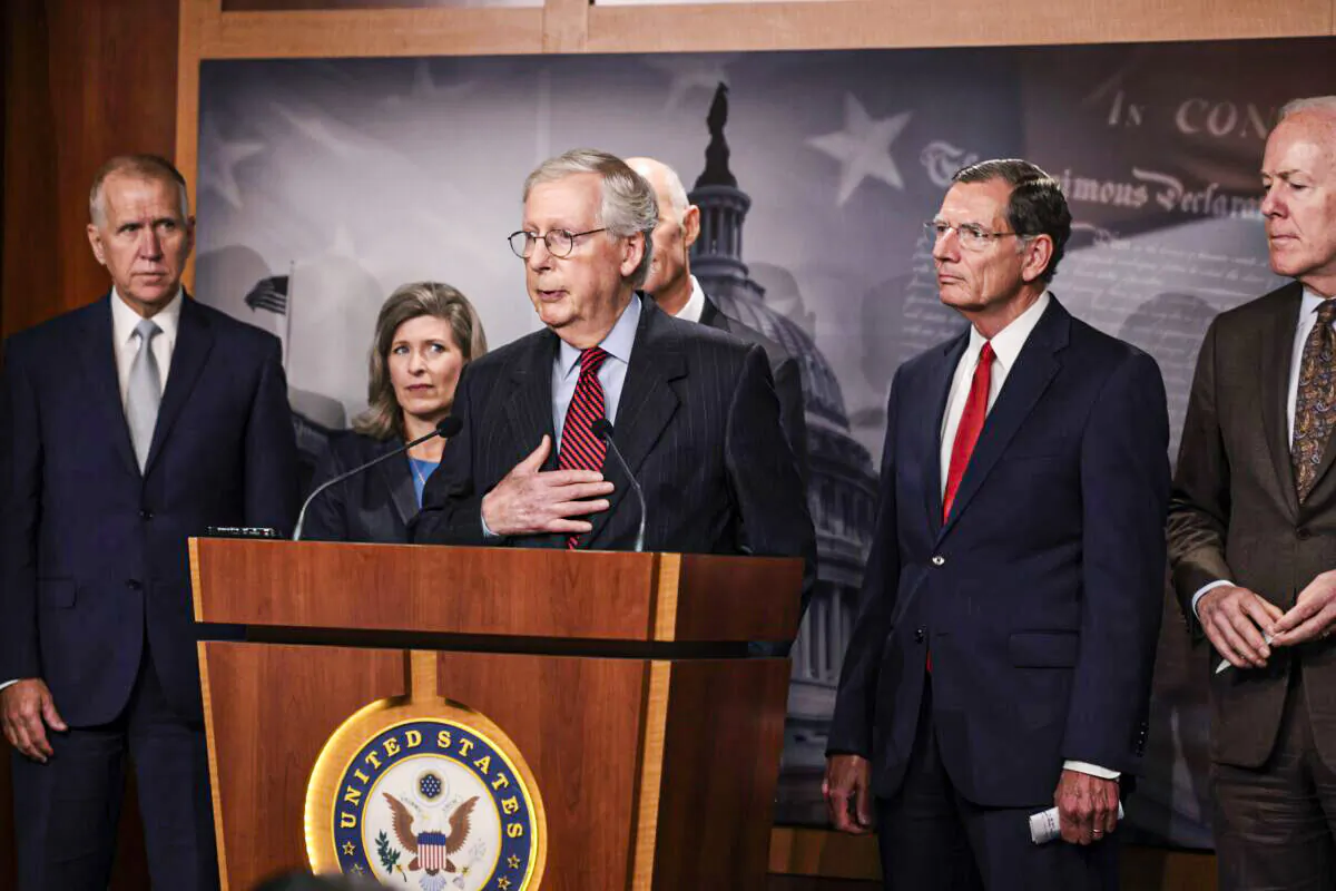 Senate Minority Leader McConnell (R-Ky.) (C) speaks to reporters as other senators stand by, in Washington on Sept. 22, 2021. (Anna Moneymaker/Getty Images)