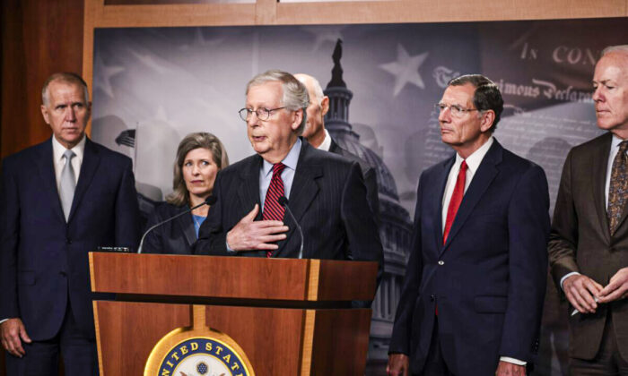Senate Minority Leader McConnell (R-Ky.) (C) speaks to reporters as other senators stand by, in Washington on Sept. 22, 2021. (Anna Moneymaker/Getty Images)