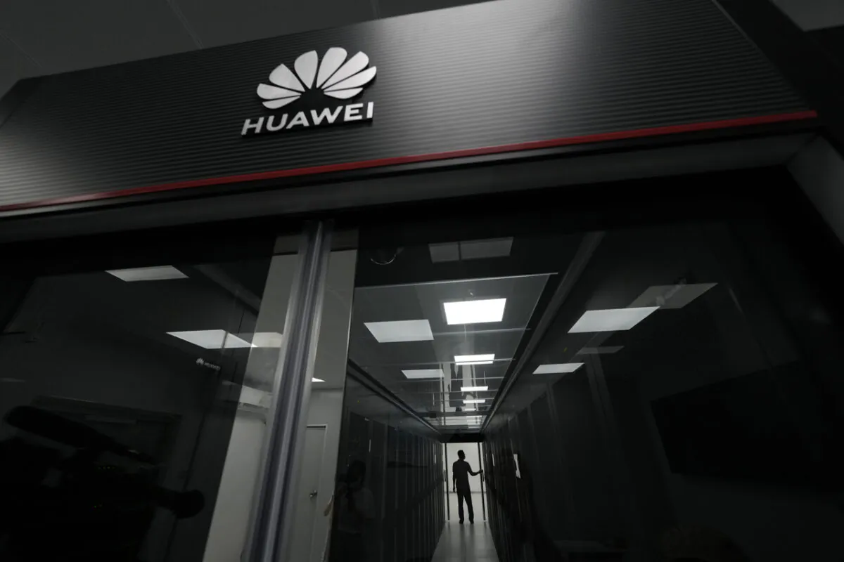 A technician stands at the entrance to a Huawei 5G data center at the Guangdong Second Provincial General Hospital in Guangzhou, in southern China's Guangdong province, Sunday, Sept. 26, 2021. (AP Photo/Ng Han Guan)