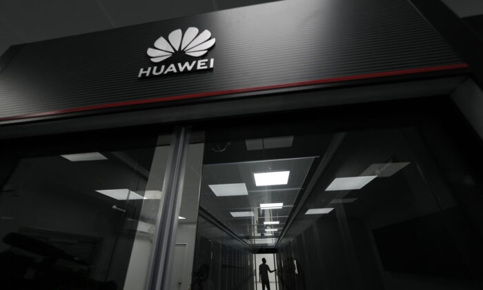 A technician stands at the entrance to a Huawei 5G data center at the Guangdong Second Provincial General Hospital in Guangzhou, in southern China's Guangdong province, Sunday, Sept. 26, 2021. (AP Photo/Ng Han Guan)