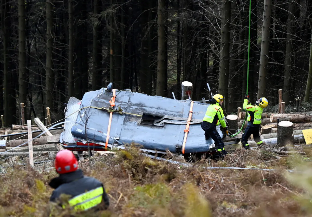 Italian fire brigade members prepare to remove crashed cable car cabin, after it collapsed in Stresa, near Lake Maggiore, Italy, on Nov. 8, 2021. (Flavio Lo Scalzo/Reuters)