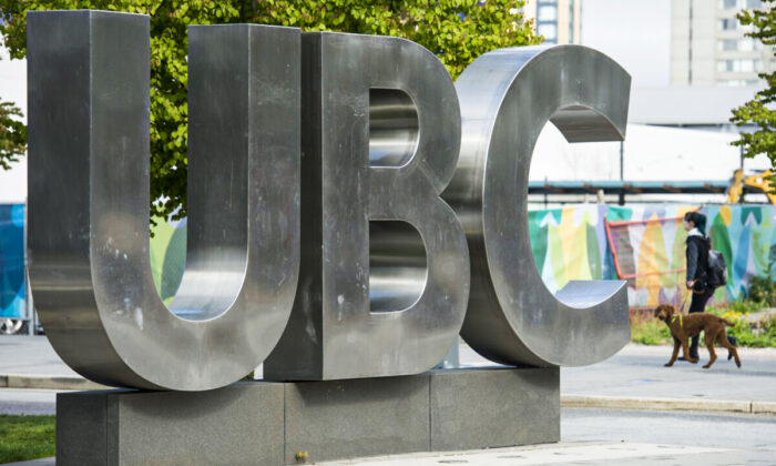 The woman and her dog will pass the UBC sign at the University of British Columbia in Vancouver on Tuesday, April 23, 2019.Canada Press / Jonathan Hayward