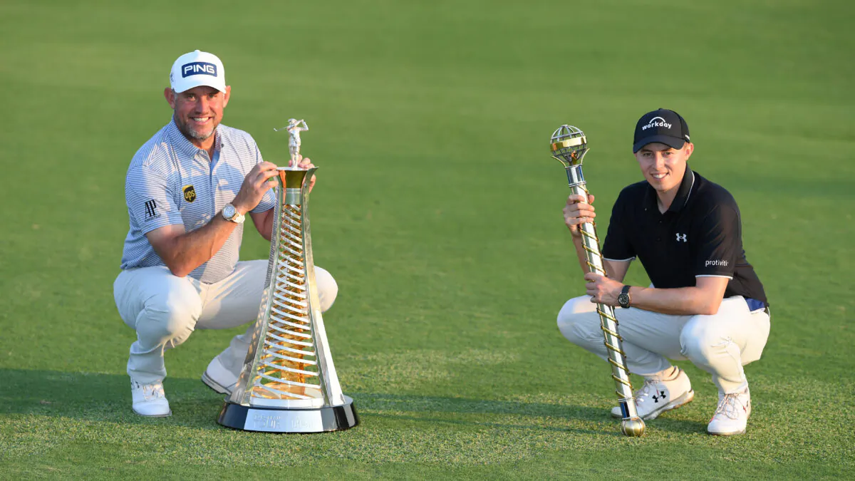 Matthew Fitzpatrick of England poses with the DP World Tour Championship trophy alongside Lee Westwood of England who poses with the Race to Dubai Trophy following Day 4 of the DP World Tour Championship at Jumeirah Golf Estates in Dubai, United Arab Emirates, on Dec. 13, 2020. (Ross Kinnaird/Getty Images)