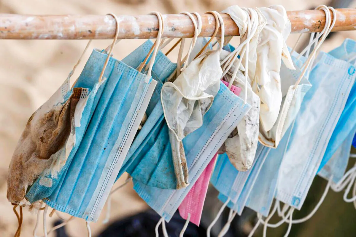 Face masks gathered by Israeli volunteers taking part in a mass beach cleanup during a one-day operation launched by some 20 Israeli associations to "beat the world record" for beach cleaning, on the shore of the city of Netanya on Oct. 30, 2020. (Jack Guez/AFP via Getty Images)