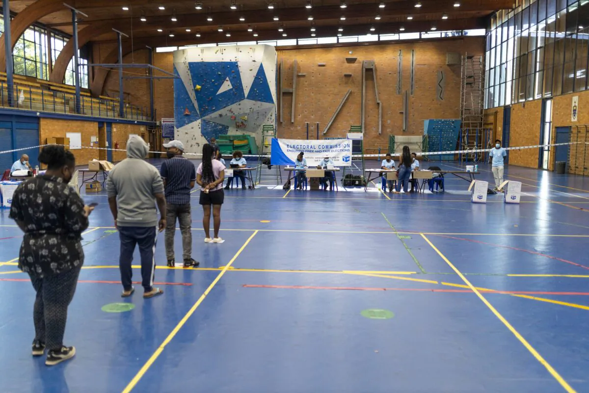 Voters stand in a queue to receive their ballots for South Africa’s local elections at the polling station at the University of the Witwatersrand (WITS) in Johannesburg on Nov. 1, 2021. (GUILLEM SARTORIO/AFP via Getty Images)