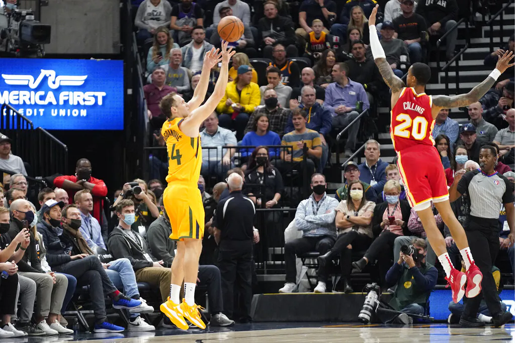 Utah Jazz forward Bojan Bogdanovic, left, shoots as Atlanta Hawks forward John Collins (20) defends during the first half of an NBA basketball game in Salt Lake City, on Nov. 9, 2021. (Rick Bowmer/AP Photo)