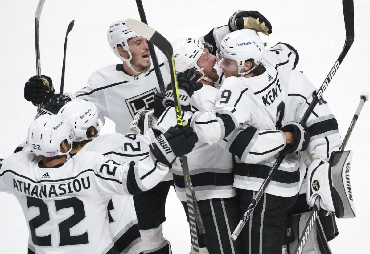 Los Angeles Kings' Adrian Kempe (9) celebrates with teammates after scoring the game-winning goal against the Montreal Canadiens during overtime in NHL hockey game in Montreal on Nov. 9, 2021. (Paul Chiasson/The Canadian Press via AP)
