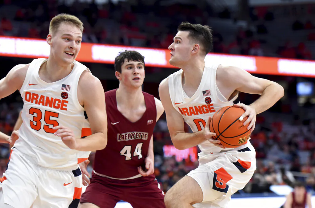 Syracuse forward Jimmy Boeheim drives against Lafayette's Chris Rubayo (44) during an NCAA college basketball game, as Syracuse guard Buddy Boeheim moves out of the way during an NCAA college basketball game in Syracuse, N.Y., on Nov. 9, 2021. (The Post-Standard via AP/Dennis Nett)