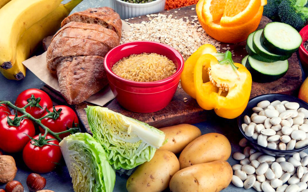 Foods high in carbohydrates on grey background. Vegan Foods high in dietary fiber, antioxidants, vitamins and minerals.