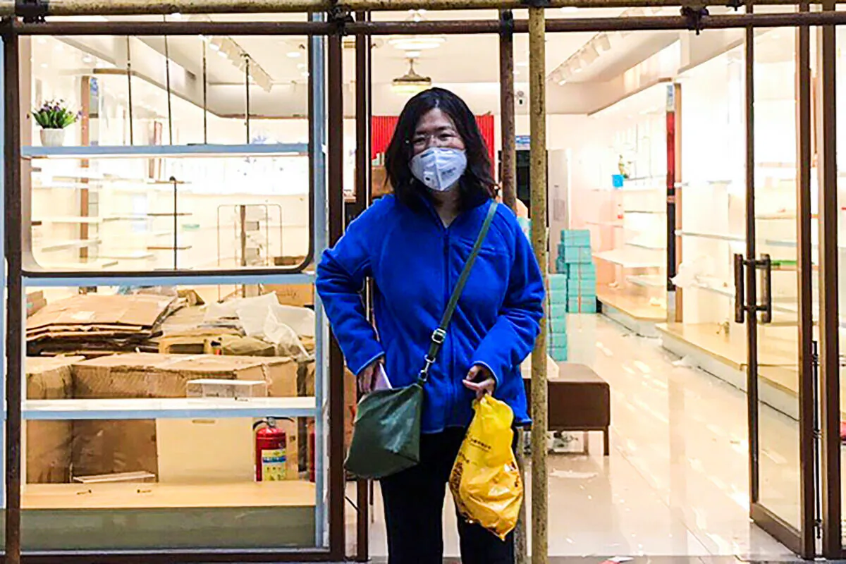 Zhang Zhan stands outside a shop during a visit to Wuhan in Hubei province, China, on April 11, 2020. (Melanie Wang via AP)