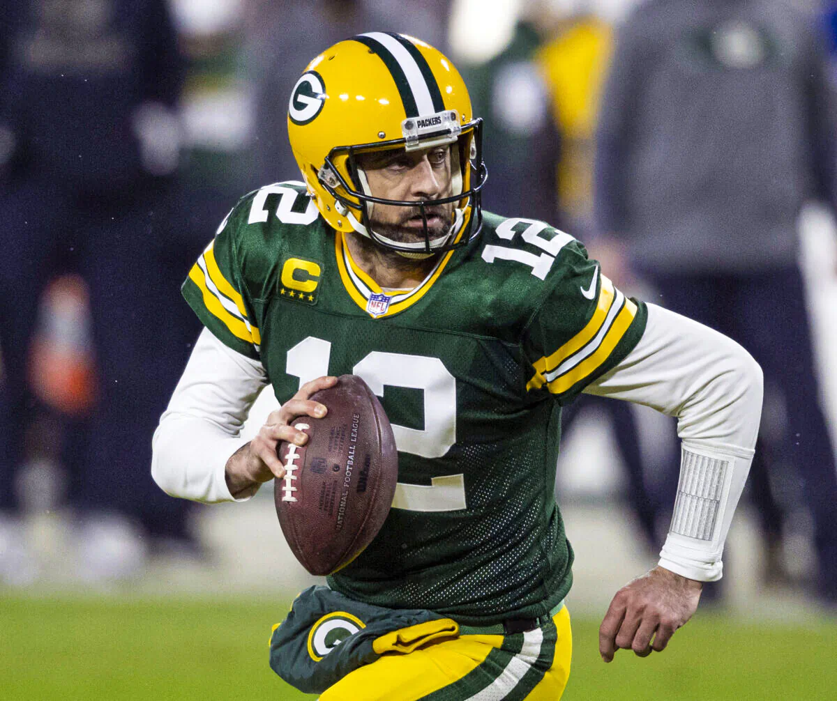 Green Bay Packers quarterback Aaron Rodgers (12) runs during an NFL divisional playoff football game against the Los Angeles Rams in Green Bay, Wis., on Jan. 16, 2021. (Jeffrey Phelps/AP Photo)