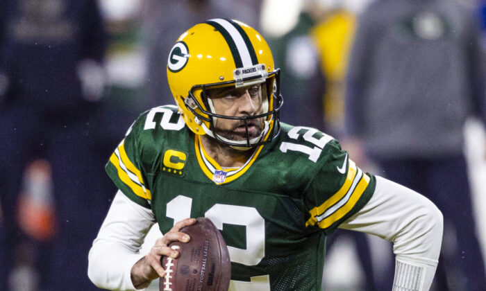 Green Bay Packers quarterback Aaron Rodgers (12) runs during an NFL divisional playoff football game against the Los Angeles Rams in Green Bay, Wis., on Jan. 16, 2021. (Jeffrey Phelps/AP Photo)