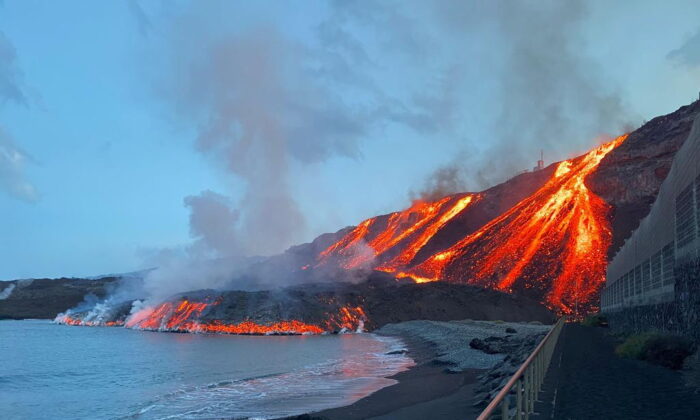 Lava spewed by Cumbre Vieja volcano reaches the Atlantic Ocean at Los Guirres beach on the Canary Island of La Palma, Spain, on Nov. 10, 2021. (Spanish Transport Ministry/Handout via Reuters)
