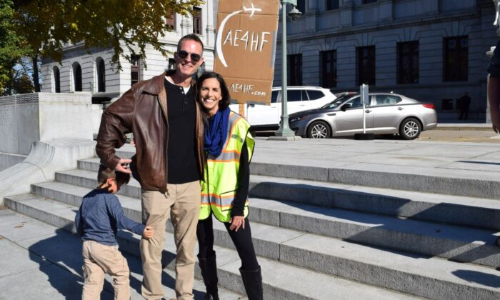 Stephanie and Kyle Atteberry, both United Airlines pilots, with their son Aaron, 4, attend a medical freedom rally in Harrisburg, Pa., on Nov. 9, 2021. (Beth Brelje/   Pezou) 