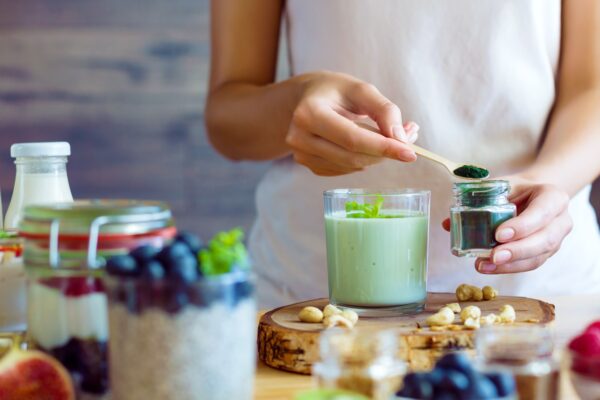 A woman preparing a spirulina yogurt for gut health