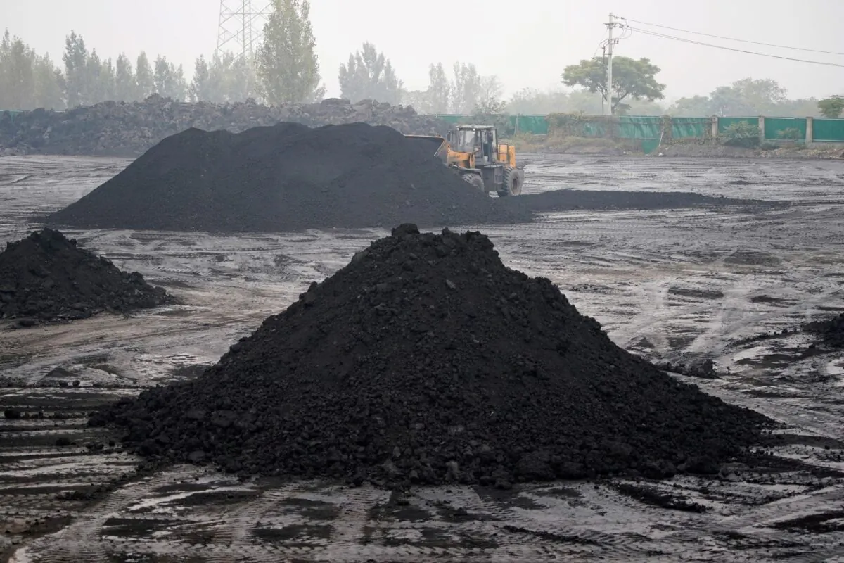 An excavator sifts through dunes of low-grade coal near a coal mine in Pingdingshan of Henan Province, China, on Nov. 5, 2021. (Aly Song/Reuters)