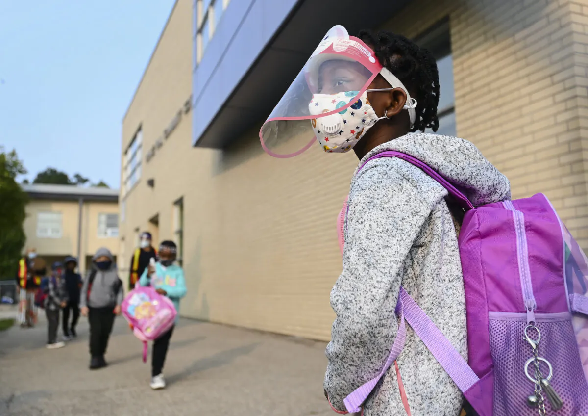 A student waits in line to enter a school in Toronto on Sept. 15, 2020. (The Canadian Press/Nathan Denette)
