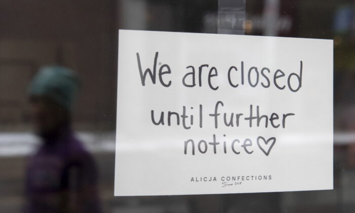 A sign on a shop window during the first pandemic lockdown, in Ottawa on March 23, 2020. (The Canadian Press/Adrian Wyld)