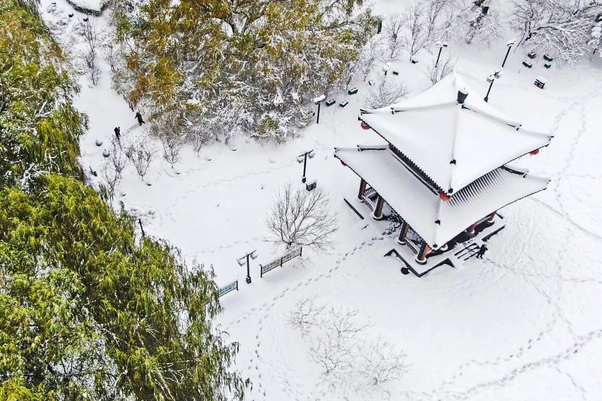 In this photo released by Xinhua News Agency, a snow covered pavilion is seen in an aerial photo at a park in Heping District in Shenyang, northeastern China's Liaoning Province on Nov. 9, 2021. (Yang Qing/Xinhua via AP)