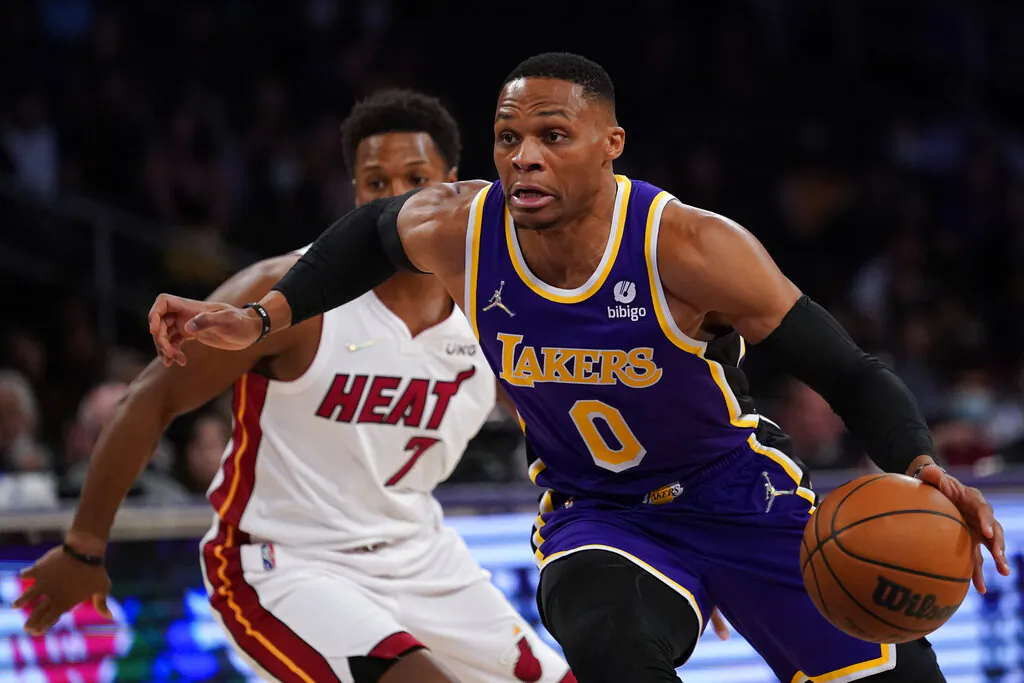 Los Angeles Lakers guard Russell Westbrook (0) drives to the hoop against Miami Heat guard Kyle Lowry (7) during the first half of an NBA basketball game in Los Angeles, on Nov. 10, 2021. (Ashley Landis/AP Photo)