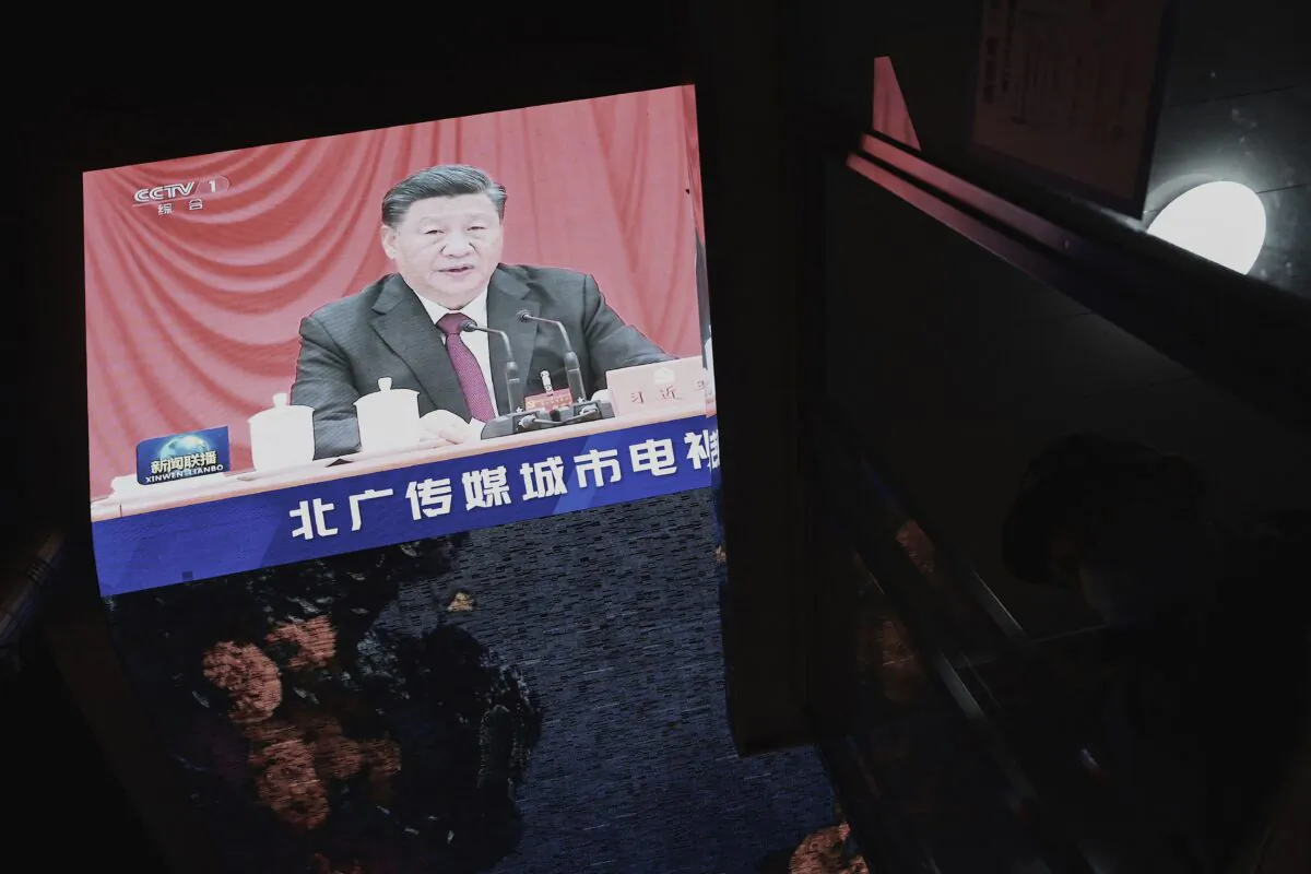 CCP leader Xi Jinping is seen in a big screen during an evening news program at a mall in Beijing on Nov. 11, 2021. (Noel Celis/AFP via Getty Images)