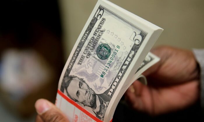 A packet of U.S. five-dollar bills is inspected at the Bureau of Engraving and Printing in Washington, on March 26, 2015. (Gary Cameron/Reuters)