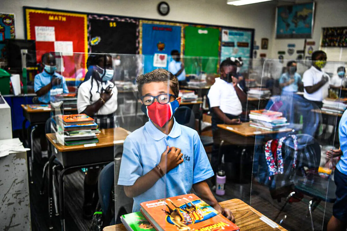 Students wear masks as they attend their first day in school after summer vacation at the St. Lawrence Catholic School north of Miami, on Aug. 18, 2021. (Chandan Khanna/AFP via Getty Images)