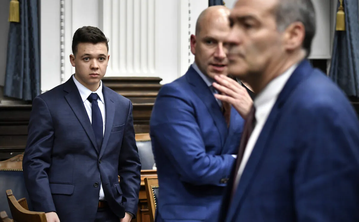 Kyle Rittenhouse, left, looks over to his attorneys Corey Chirafisi, center, and Mark Richards after getting off the witness stand during his trial at the Kenosha County Courthouse in Kenosha, Wis., on Nov. 10, 2021. (Sean Krajacic-Pool/Getty Images)