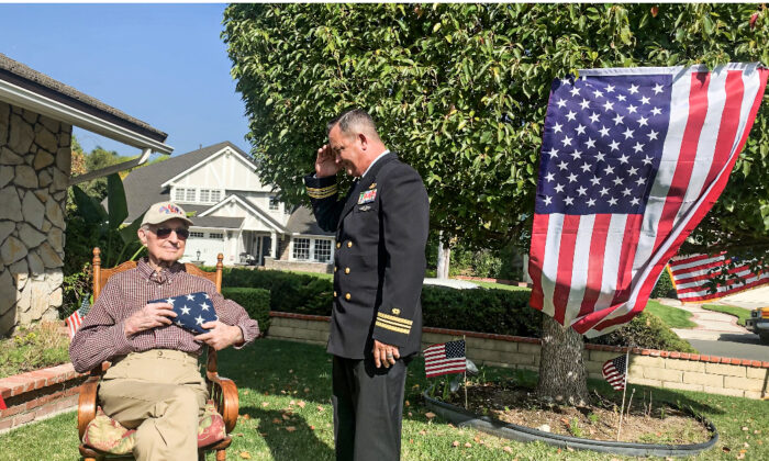 The U.S. Navy Reserve Lieutenant Colonel and Brea Mayor Steven Vargas handed an American flag to Bradley at his birthday celebration, Bradley held the flag dearly to his heart. (Linda Jiang/The Epoch Times)
