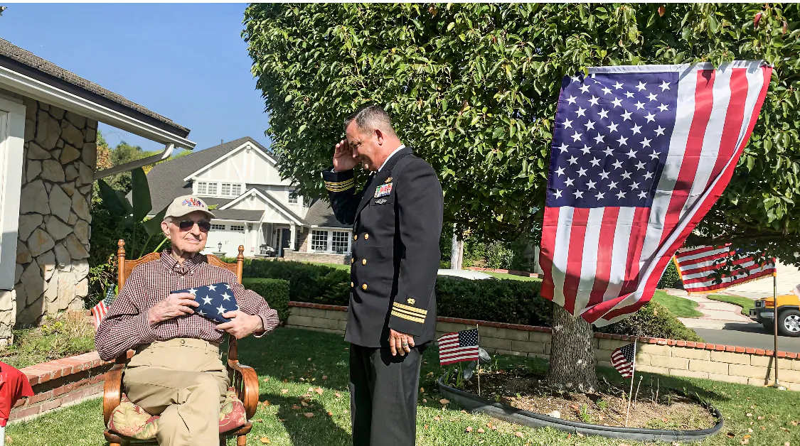 The U.S. Navy Reserve Lieutenant Colonel and Brea Mayor Steven Vargas handed an American flag to Bradley at his birthday celebration, Bradley held the flag dearly to his heart. (Linda Jiang/The Epoch Times)
