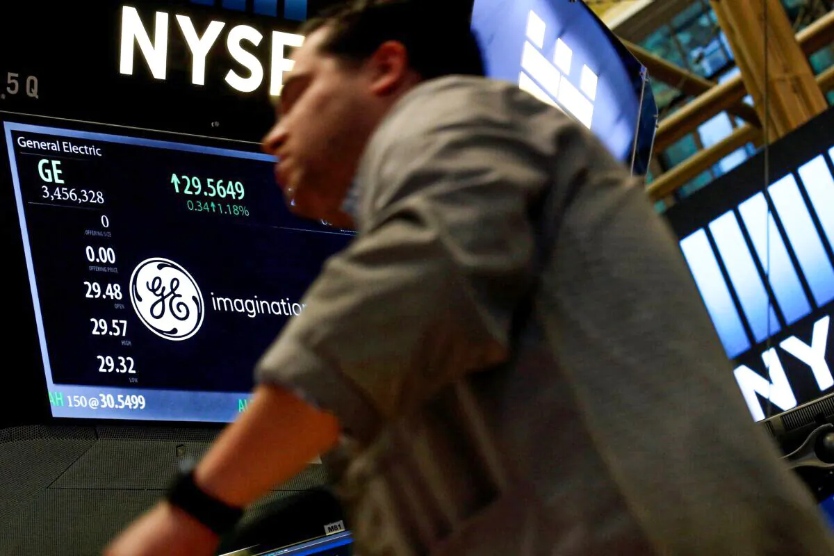 A trader passes by the post where General Electric is, at the New York Stock Exchange (NYSE), in New York City, on Oct. 31, 2016. (Brendan McDermid/Reuters)