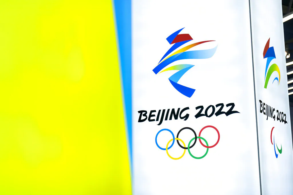 The logos for the 2022 Beijing Winter Olympics and Paralympics are seen during an exhibit at a visitors center at the Winter Olympic venues in Yanqing on the outskirts of Beijing, Feb. 5, 2021. (Mark Schiefelbein/AP Photo) 