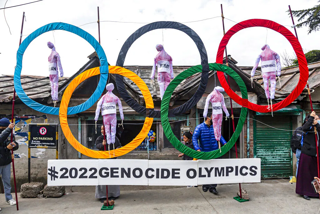 Exiled Tibetans use the Olympic Rings as a prop as they hold a street protest against the holding of 2022 Winter Olympics in Beijing, in Dharmsala, India, on Feb. 3, 2021. (Ashwini Bhatia/AP Photo)