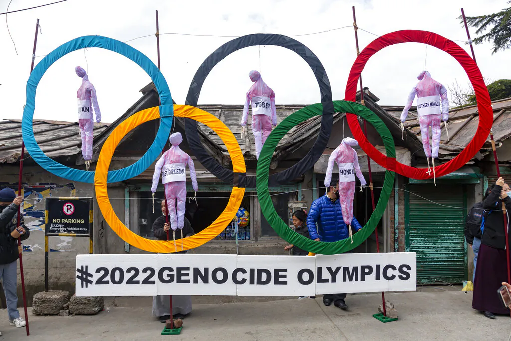 Exiled Tibetans use the Olympic Rings as a prop during a protest against the holding of 2022 Winter Olympics in Beijing, in Dharmsala, India, on Feb. 3, 2021. (Ashwini Bhatia/AP Photo)