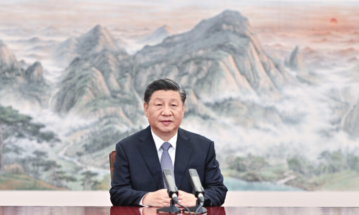 Chinese leader Xi Jinping delivers a keynote speech for the Asia-Pacific Economic Cooperation (APEC) CEO Summit via video, from Beijing on Nov. 11, 2021. (Li Xueren/Xinhua via AP) <br />