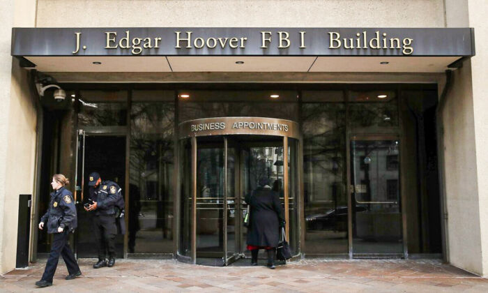 Law enforcement officers walk out of the J. Edgar Hoover FBI Building in Washington on Jan. 28, 2019. (Mark Wilson/Getty Images)