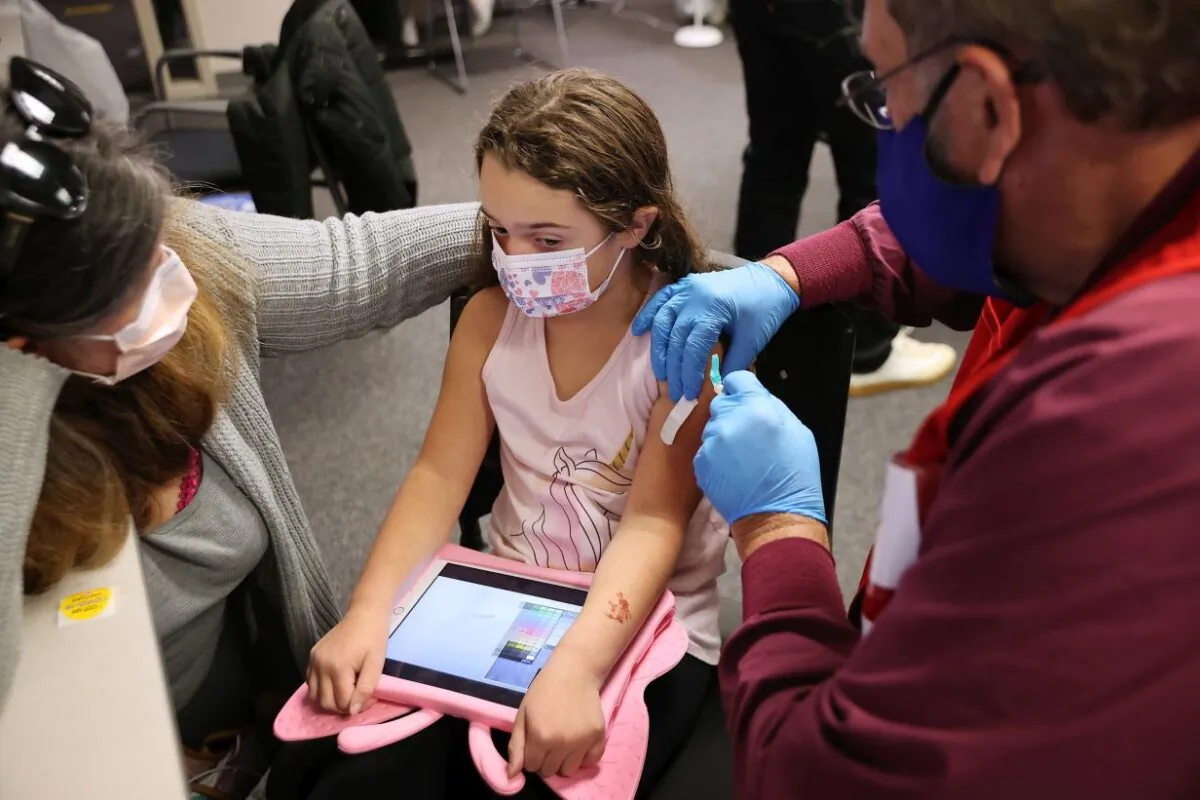 A child receives the Pfizer BioNTech COVID-19 vaccination at the Fairfax County Government Center in Annandale, Va., on Nov. 4, 2021. (Chip Somodevilla/Getty Images)