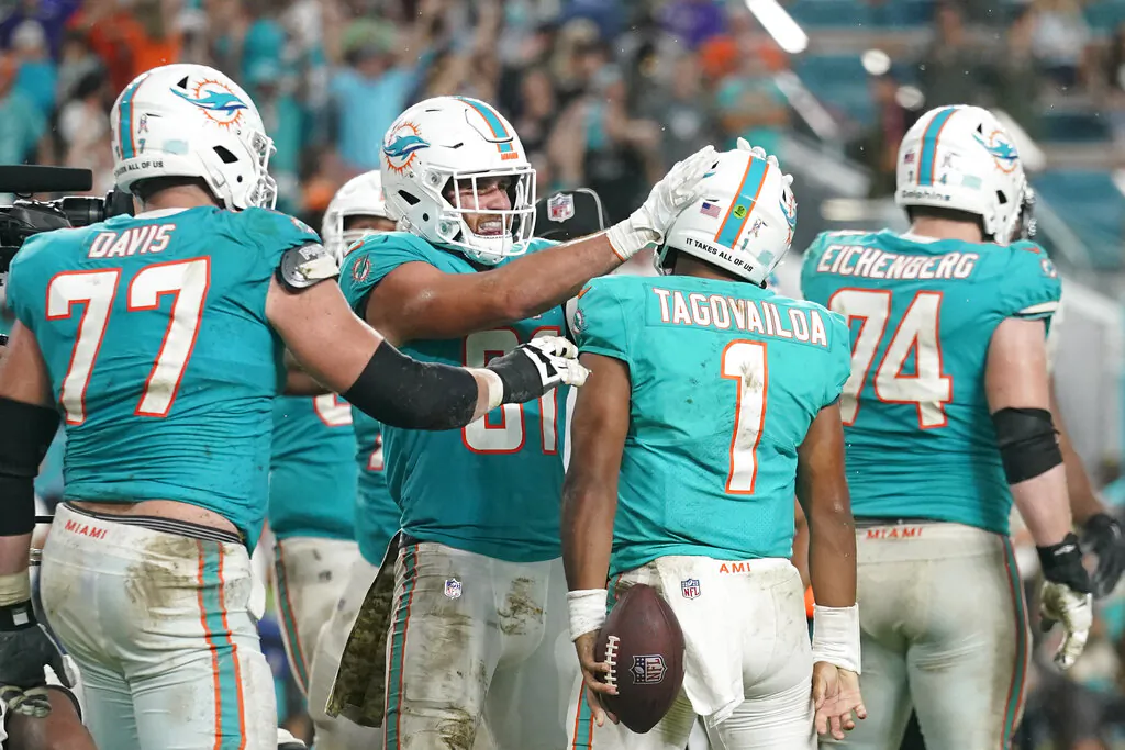 Miami Dolphins tight end Durham Smythe (81) celebrates with Miami Dolphins quarterback Tua Tagovailoa (1) after Tagovailoa scored a touchdown during the second half of an NFL football game against the Baltimore Ravens. The Dolphins defeated the Ravens 22-10, in Miami Gardens, Fla., on Nov. 11, 2021. (Lynne Sladky/AP Photo)