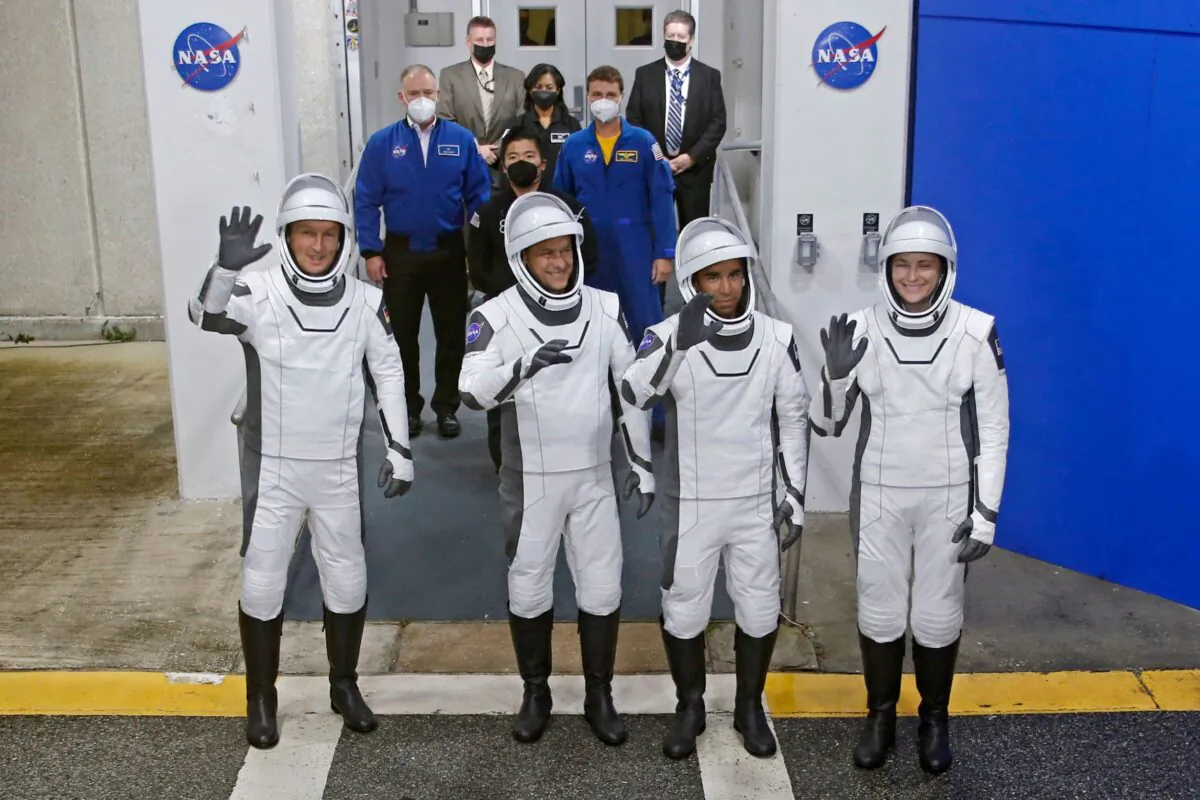 European Space Agency (ESA) astronaut Matthias Maurer of Germany, NASA astronauts Raja Chari, Tom Marshburn, and Kayla Barron wave while departing the crew quarters for launch aboard a SpaceX Falcon 9 rocket on a mission to the International Space Station at the Kennedy Space Center in Cape Canaveral, Fla., on Nov. 10, 2021. (Joe Skipper/Reuters)