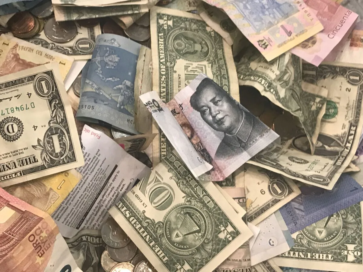 U.S. dollars and other world currencies lie in a charity receptacle at Pearson international airport in Toronto, Ontario, Canada on June 13, 2018. (Chris Helgren/Reuters)
