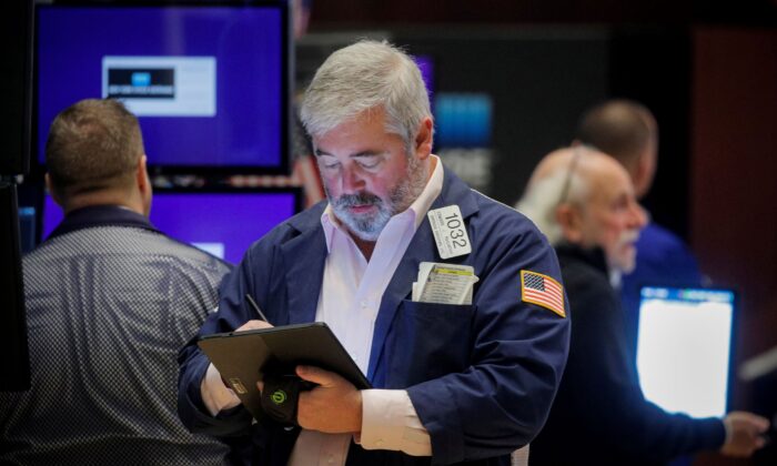 Traders work on the floor of the New York Stock Exchange (NYSE) in New York City on Nov. 8, 2021. (Brendan McDermid/Reuters)