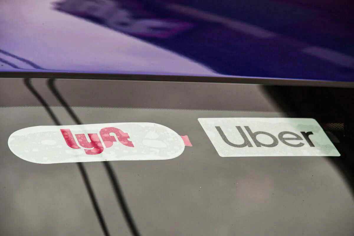 A rideshare driver displays stickers for rideshare companies Uber and Lyft in Los Angeles on Aug. 6, 2020. (Robyn Beck/AFP via Getty Images)