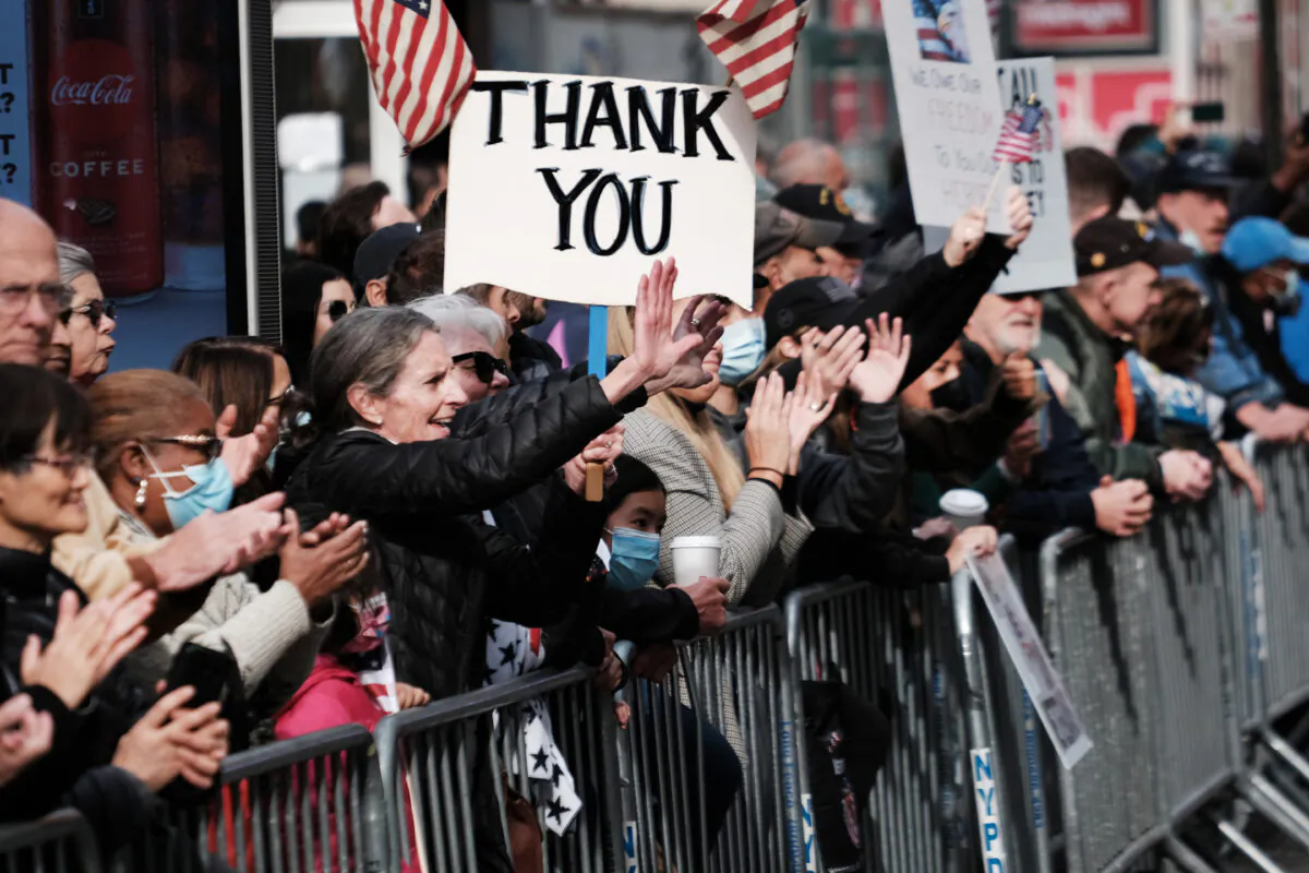 Spectators watch the Veterans Day Parade in New York City, on Nov. 11, 2021. (Spencer Platt/Getty Images)